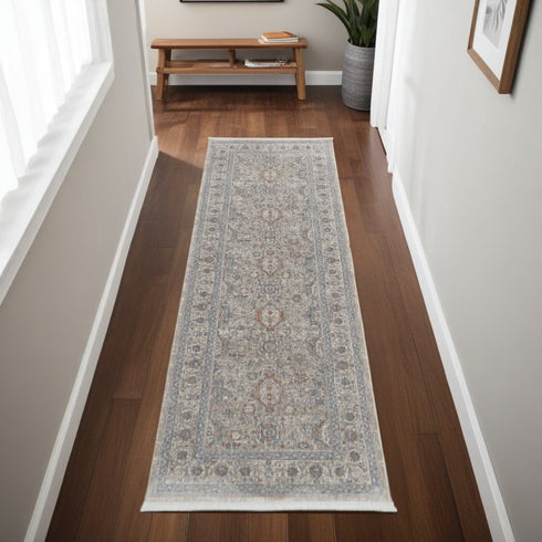 7' X 10' Silver Taupe and Blue Oriental Power Loom Worn Faded Area Rug With Fringe